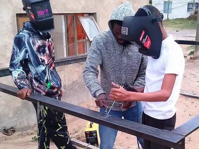Thulani M teaches members welding skills
